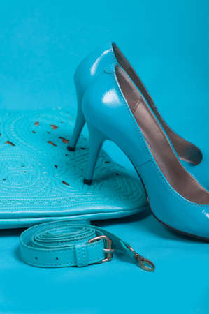 Beautiful blue shoes and handbag on blue backgroundの写真素材