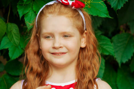 Girl in a beautiful dress in cherry gardenの写真素材