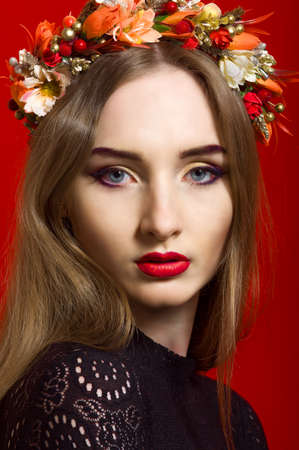 Beautiful girl with long hair wearing a wreath of flowersの写真素材