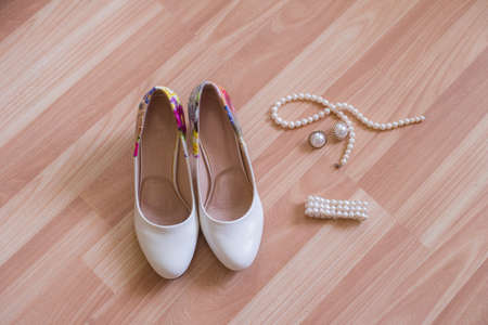 Wedding shoes bracelet and earrings a necklace of pearlsの写真素材
