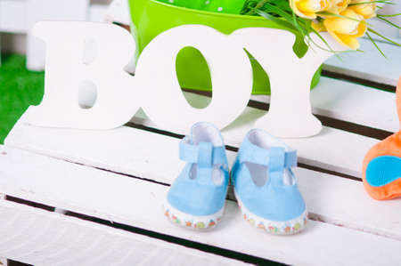Blue baby shoes and flowersの写真素材