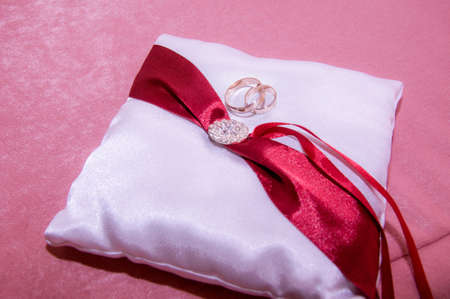 wedding rings on a silk cushionの写真素材