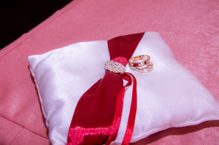 wedding rings on a silk cushionの写真素材