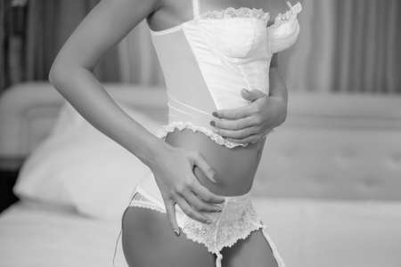 girl in a white sexy lingerie in the bedroomの写真素材