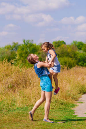 Girls sister in a field with  flowersの写真素材