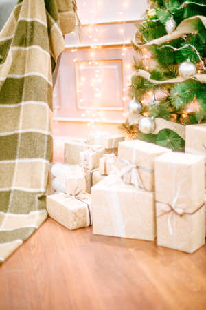 Presents under Christmas Tree in living room. Family Holiday New Year at Homeの写真素材