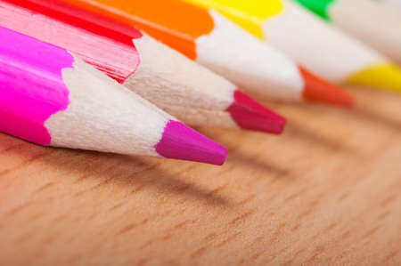 Set of drawing tools on a wooden background. Color pencils on desk