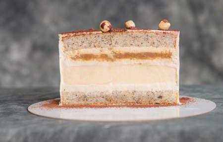 chocolate cake on a dark background adorned with nuts