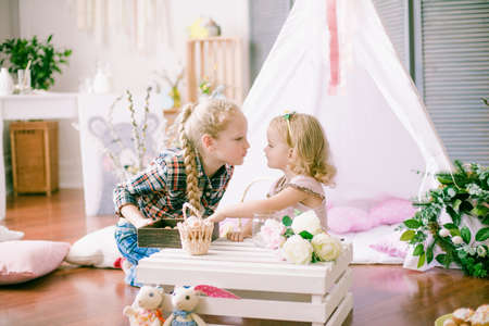 Lovely sister girls. Colorful preparations for the Easter holiday. The children are having funの写真素材