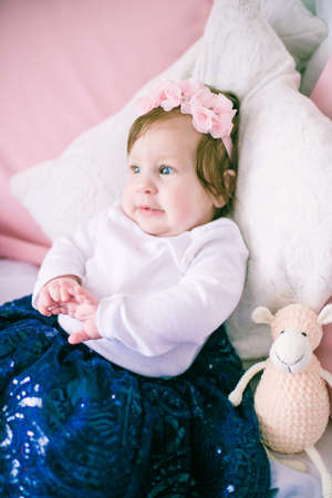 Cute girl, princess, a child in dress on the pink bedprincess, a child in a dress on the pink bedの写真素材