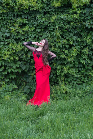 young girl in an evening fashionable red dressの写真素材