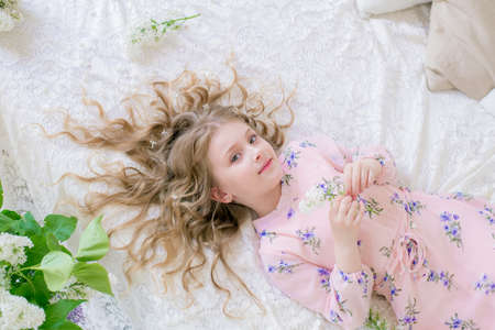 Little girl with lilac flowers