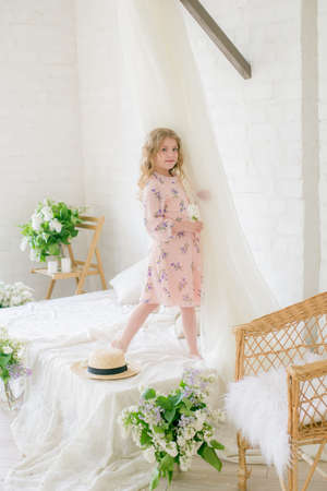 Little girl with lilac flowersの写真素材