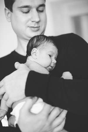 father holding newborn babyの写真素材