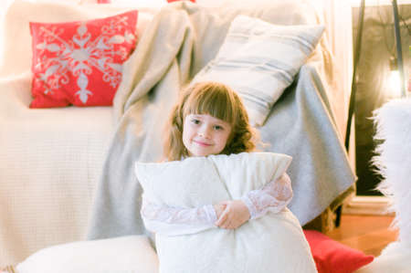 Cute girl with long hair in the room with Christmas decorations and gifts. Christmas moodの写真素材