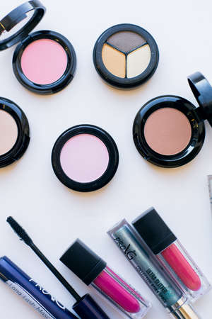 Makeup and makeup brushes on the table. Eye shadow, lipstick, gloss, mascara. Materials and tools for makeup. Beauty and fashionの写真素材
