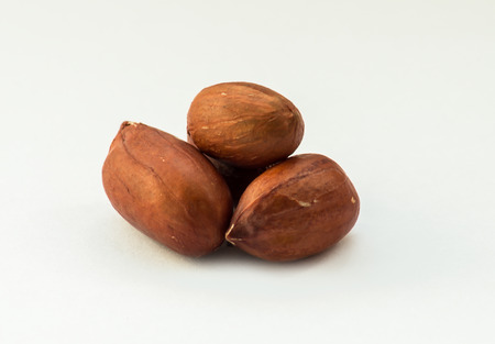 Some peanuts on the white background