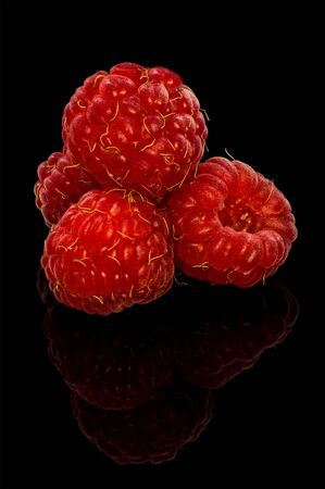Stack of the raspberries isolated on black