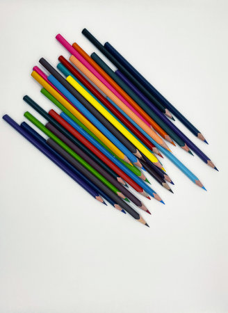 Lots of colored sharpened pencils on a white backgroundの写真素材