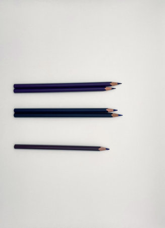 Three colored pencils on a white background