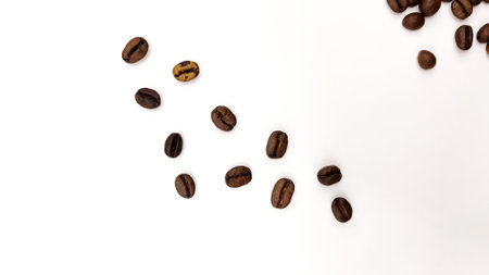 Coffee beans falling in the air isolated on a white background. Coffee beans flying.の写真素材