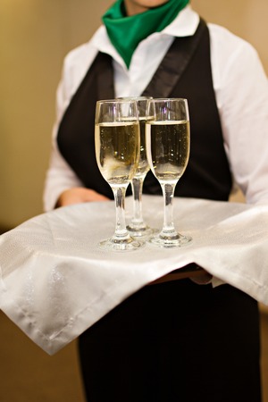 Photo of Three glasses of Champagne a waiterの写真素材