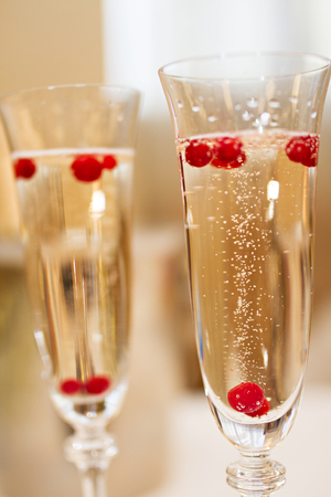 Photo of Two glasses of Champagne with berriesの写真素材
