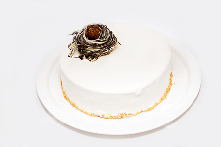 Zephyr cake with nuts on white plateの写真素材