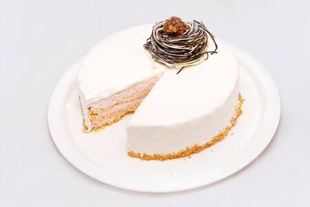 Zephyr cake with nuts without a part on white plate