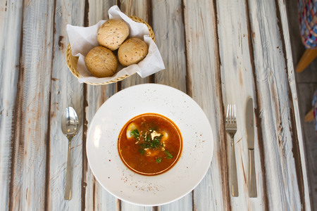 Ukrainian or Russian borscht with bread on wooden tableの写真素材