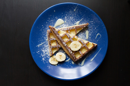 Belgium waffle with a slice of lime an a blue plateの写真素材
