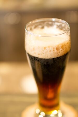 Glass - pint- of dark beer with foam