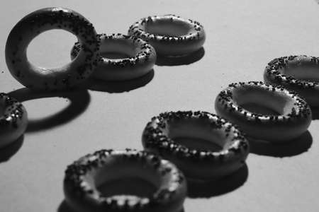 Composition of bagels with poppy seeds and dried leaves of black teaの写真素材