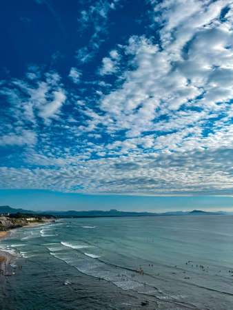Waves and surfers at Biarritz, France, vertical photo, space for textの写真素材