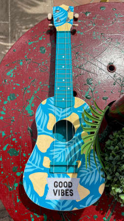 Colored small guitar with the inscription Good vibes.Vertical photoの写真素材