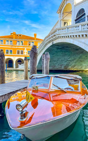 Venetian water taxi boat near Rialto bridge in Venice, Italy, vertical photoの写真素材