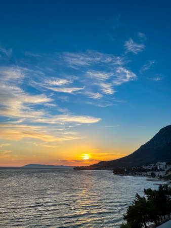Summer Sunset over the beach, Makarska, Croatia, vertical photoの写真素材