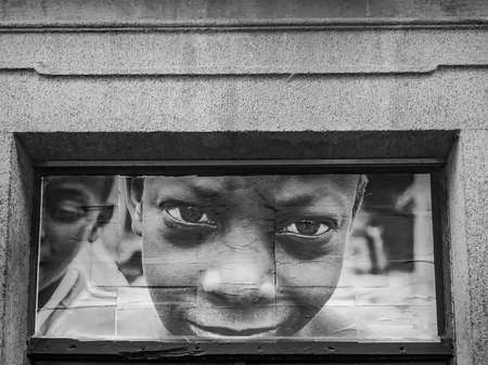 Funchal, Madeira, January 02, 2019, Photo of boy on the wall of a house in the street of Funchal, Madeira.のeditorial素材