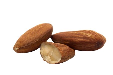 Almond close - up isolated on white. Whole almonds and half a nut.