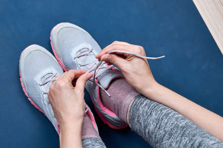 Sports woman tying her shoelaces.の写真素材