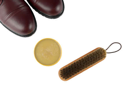 Closeup of shoe and shoe care accessories: wax and brush