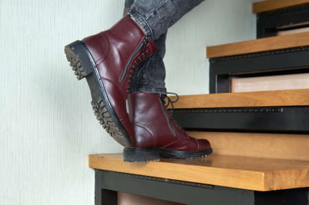 Woman wearing stylish boots on stairs indoors, closeup