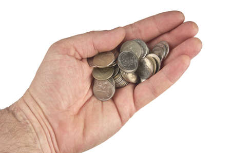 Heap of coins in hand isolated on white background with clipping path.