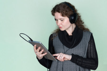 Close-up portrait of beautiful young woman with headphones around neck.の写真素材