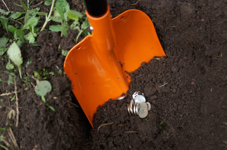 Coins dug out of the ground. concept of treasure finding