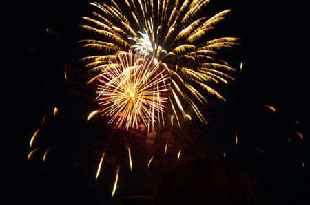 Low angle view of firework and balloon against sky at nightの写真素材