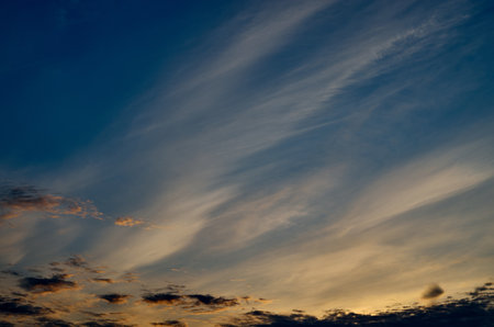 Dramatic yellow and orange sunset sky with clouds and sun rays