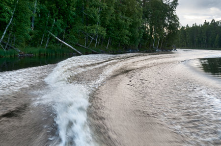 Trail from a speedboat on the waterの写真素材