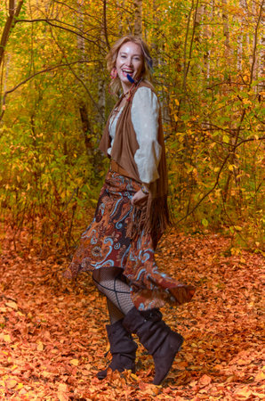 Dancing woman in bright autumn parkの写真素材
