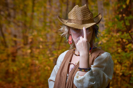Portrait of a beautiful woman in autumn parkの写真素材